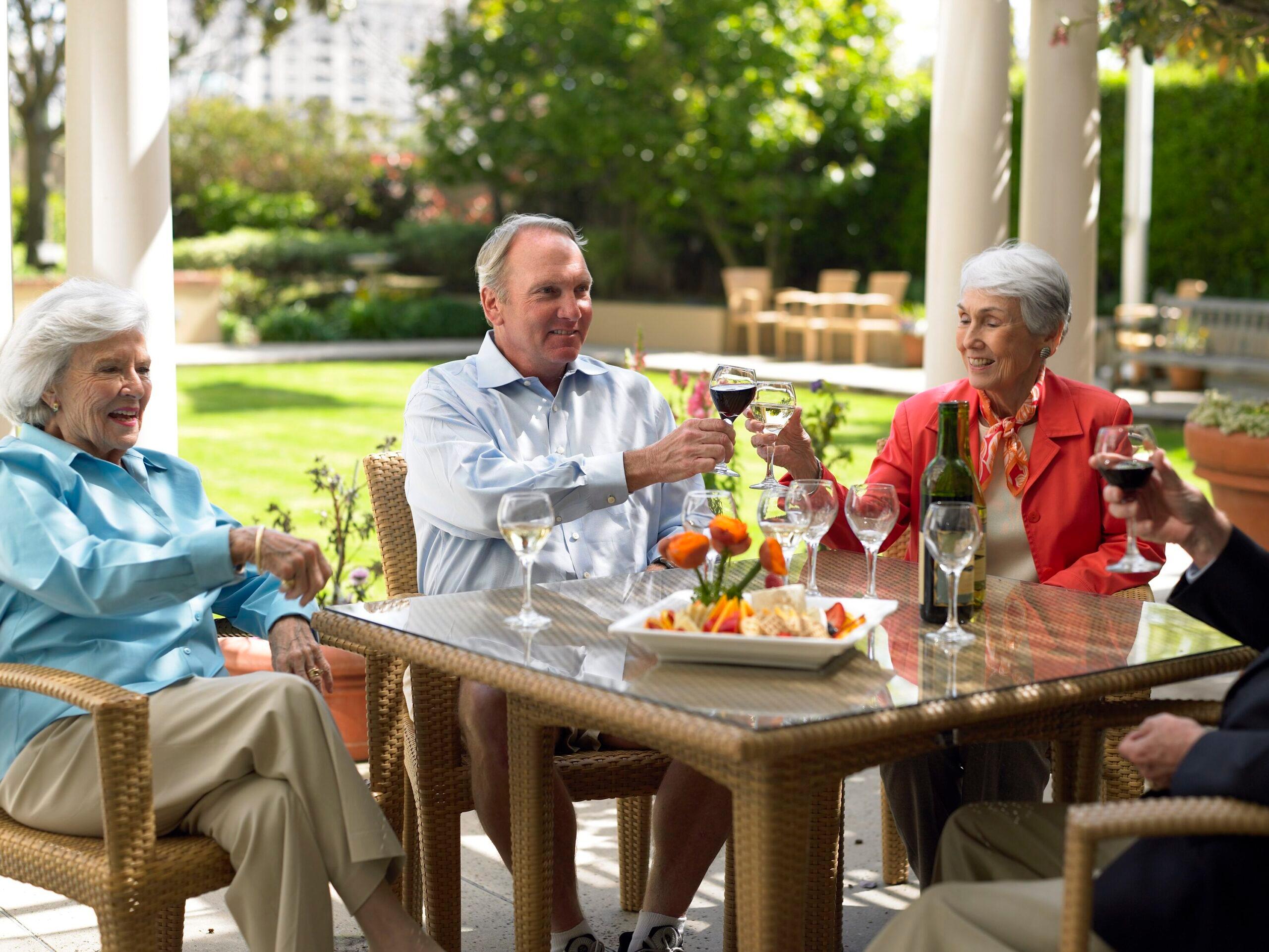 Happy hour at The Peninsula Regent - Older adults gather and cheers with wine and a snack tray