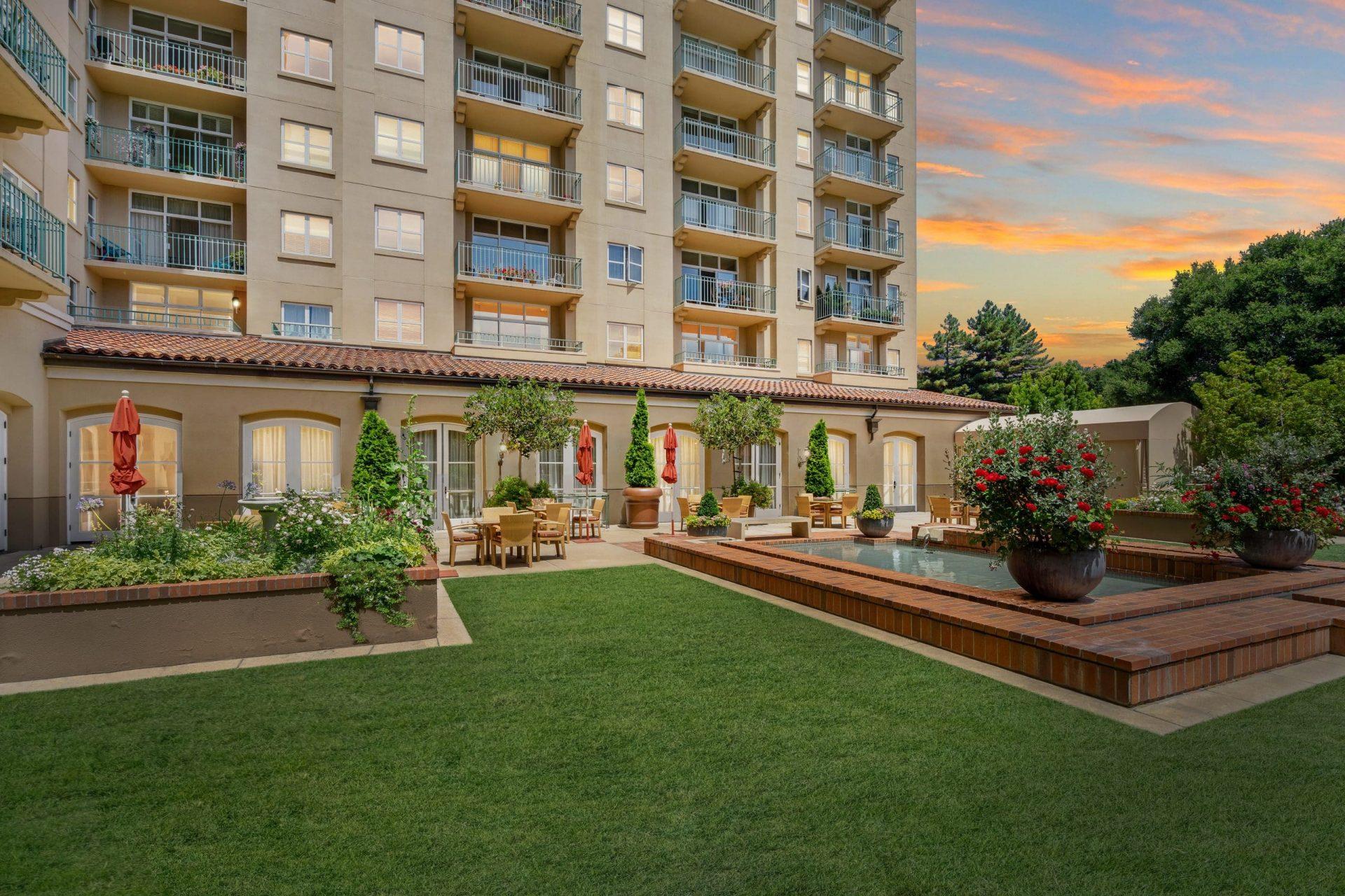 A manicured courtyard and sitting area outside of the senior condos in San Mateo