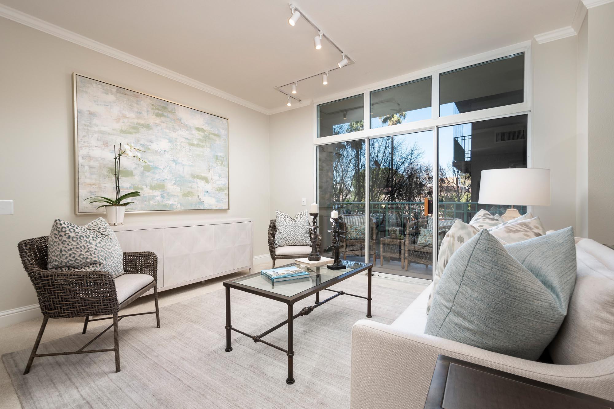 The Peninsula Regent - Unit 219 - Living room with glass doorway to patio