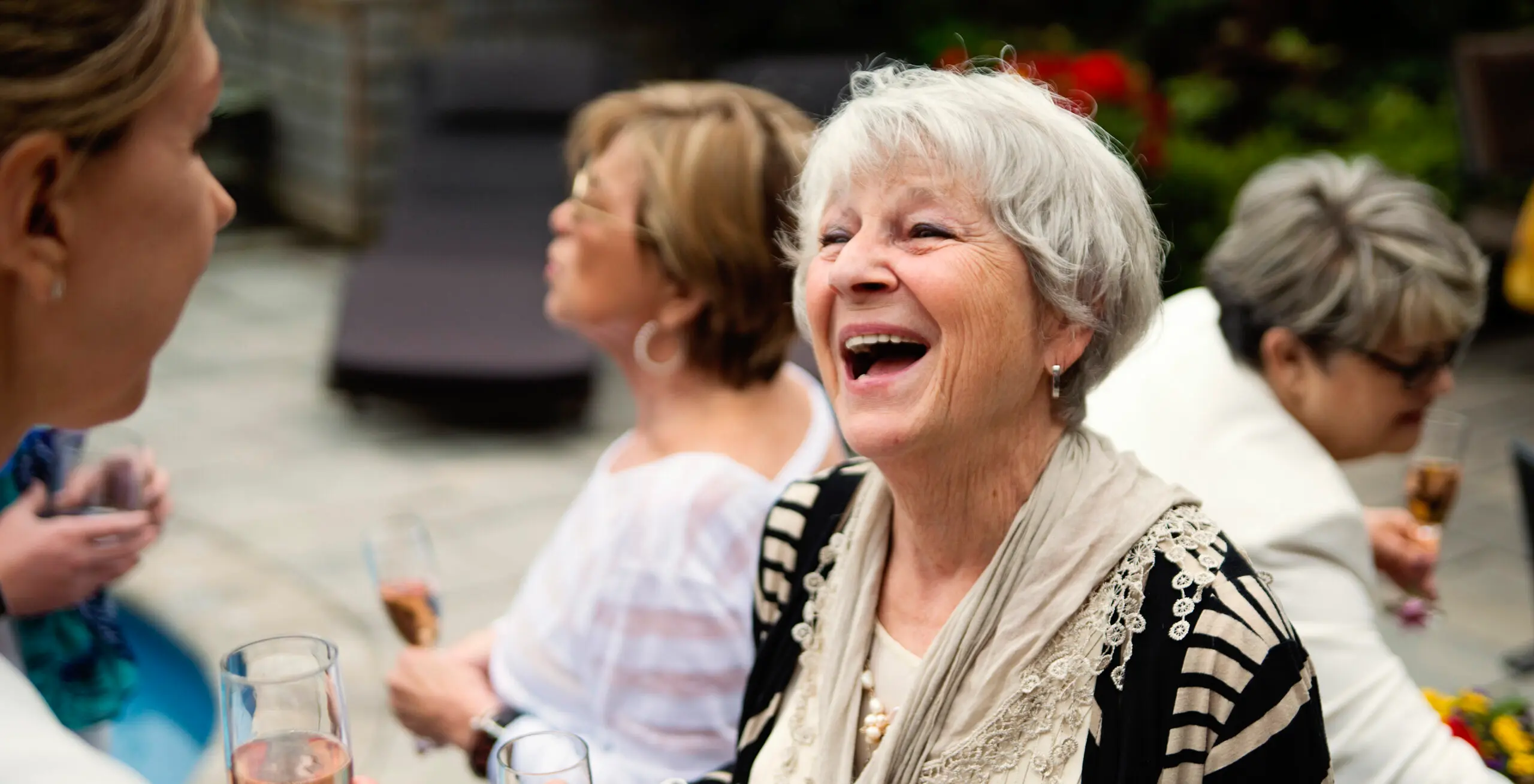 Different generations of women celebrating in garden party.